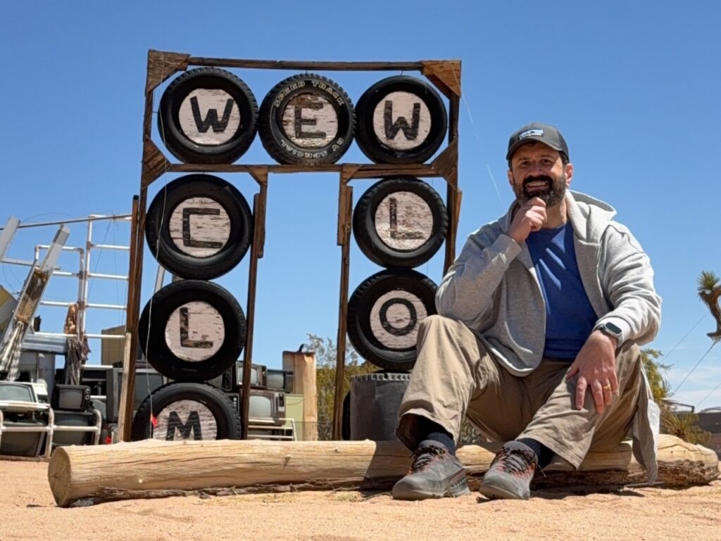 david-welcome Man sitting in front of a found art sculpture.