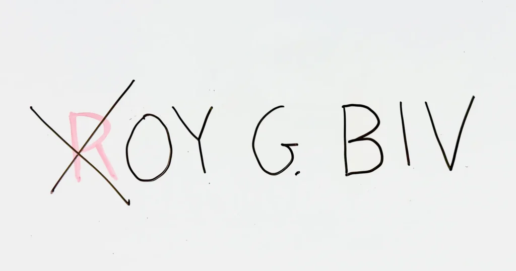 Handwritten “ROY G. BIV” on a whiteboard. The R is written in red, while the remaining letters are black. A large black X crosses out the red R.