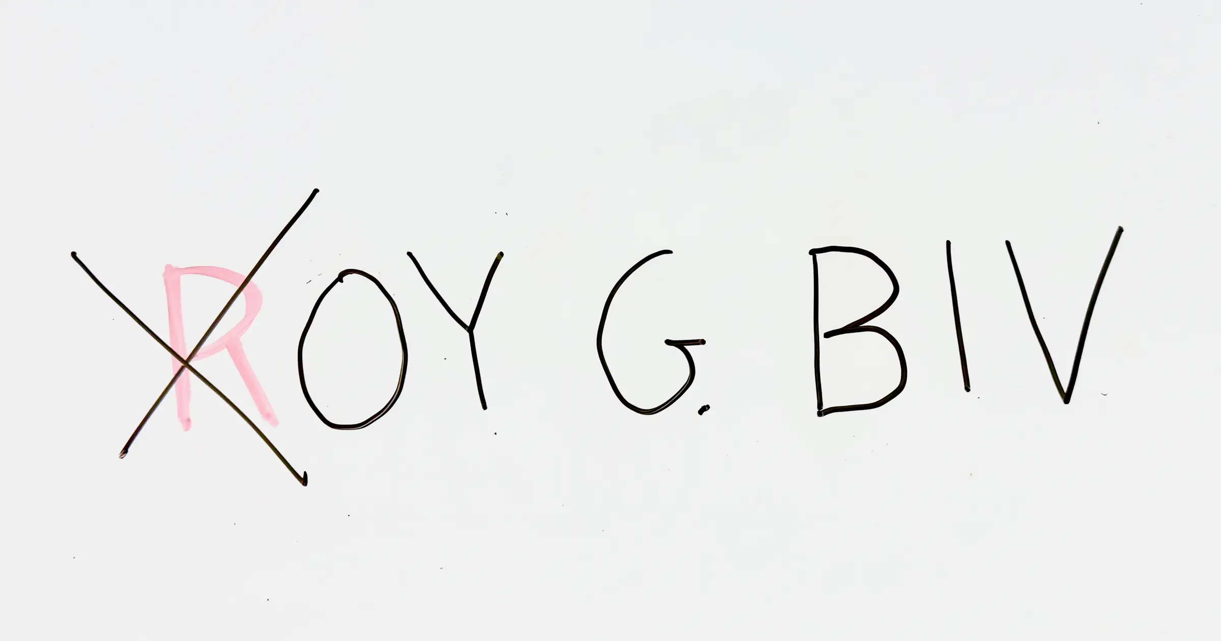 Handwritten “ROY G. BIV” on a whiteboard. The R is written in red, while the remaining letters are black. A large black X crosses out the red R.